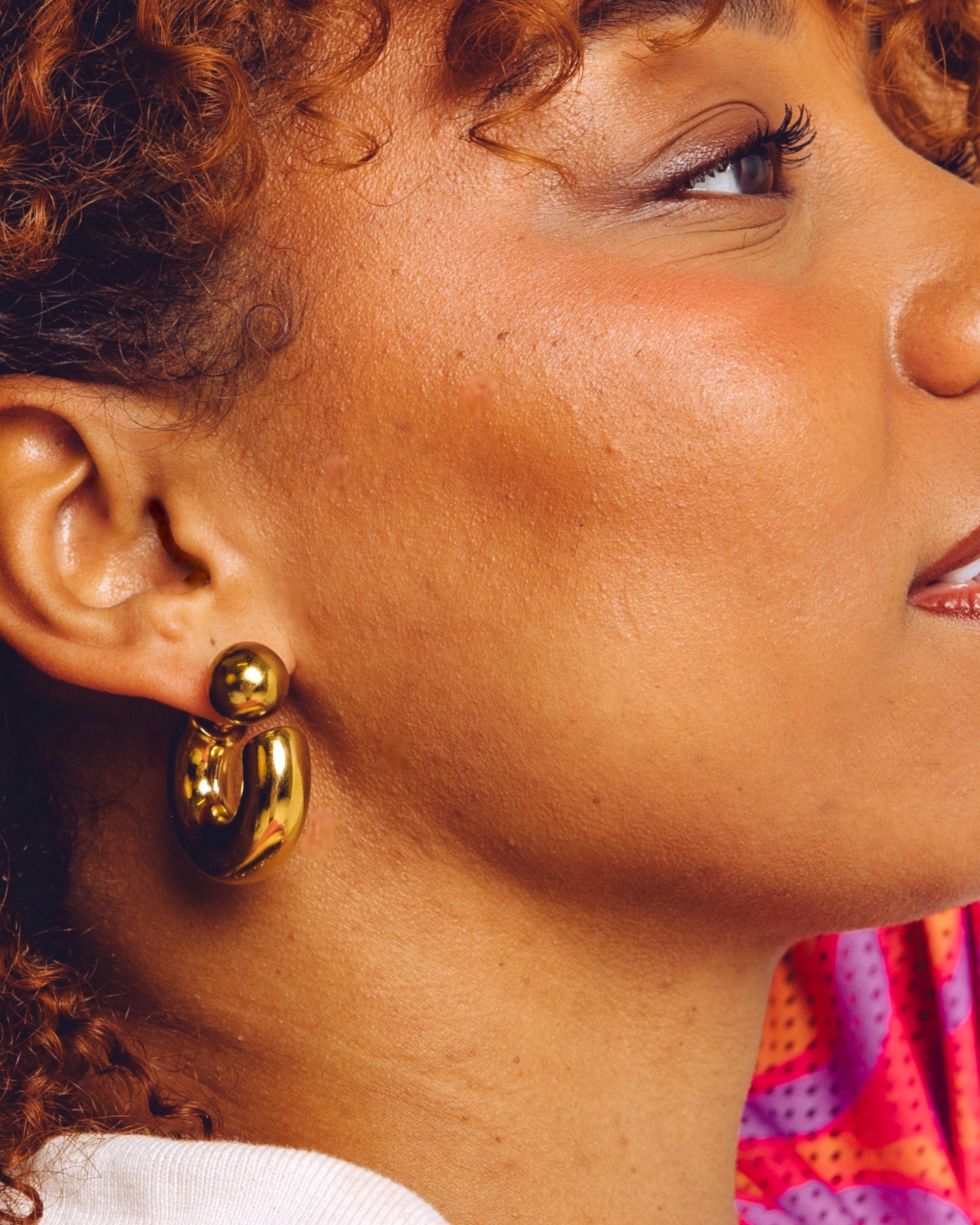 Arc chunky gold hoop earrings worn by model — bold statement earrings by STXCKD