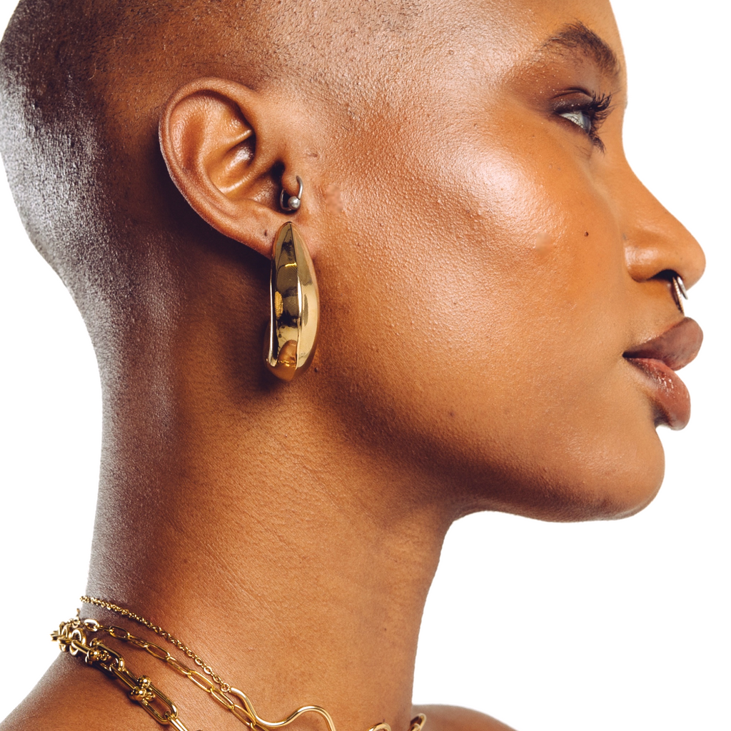 Lune everyday gold hoop earrings worn by model — smooth statement earrings by STXCKD