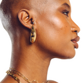 Lune everyday gold hoop earrings worn by model — smooth statement earrings by STXCKD