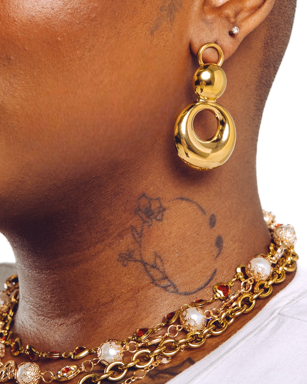 Orbit bold gold drop earrings close up on model — statement jewellery by STXCKD